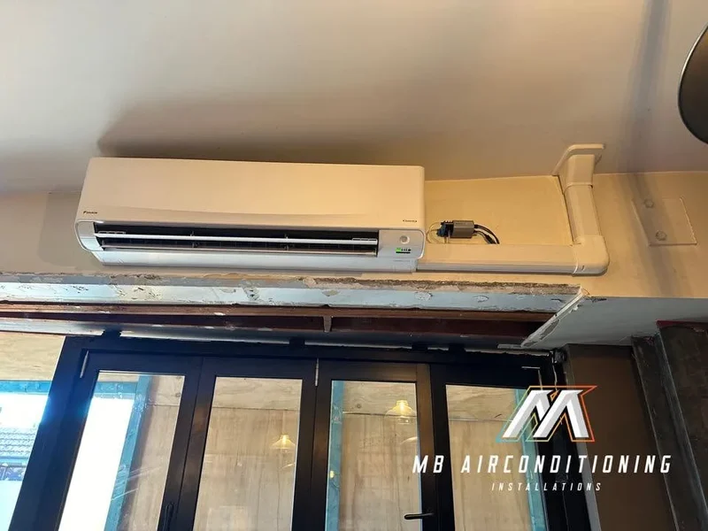 Split system installed above the entry doors of a Sydney shopfront