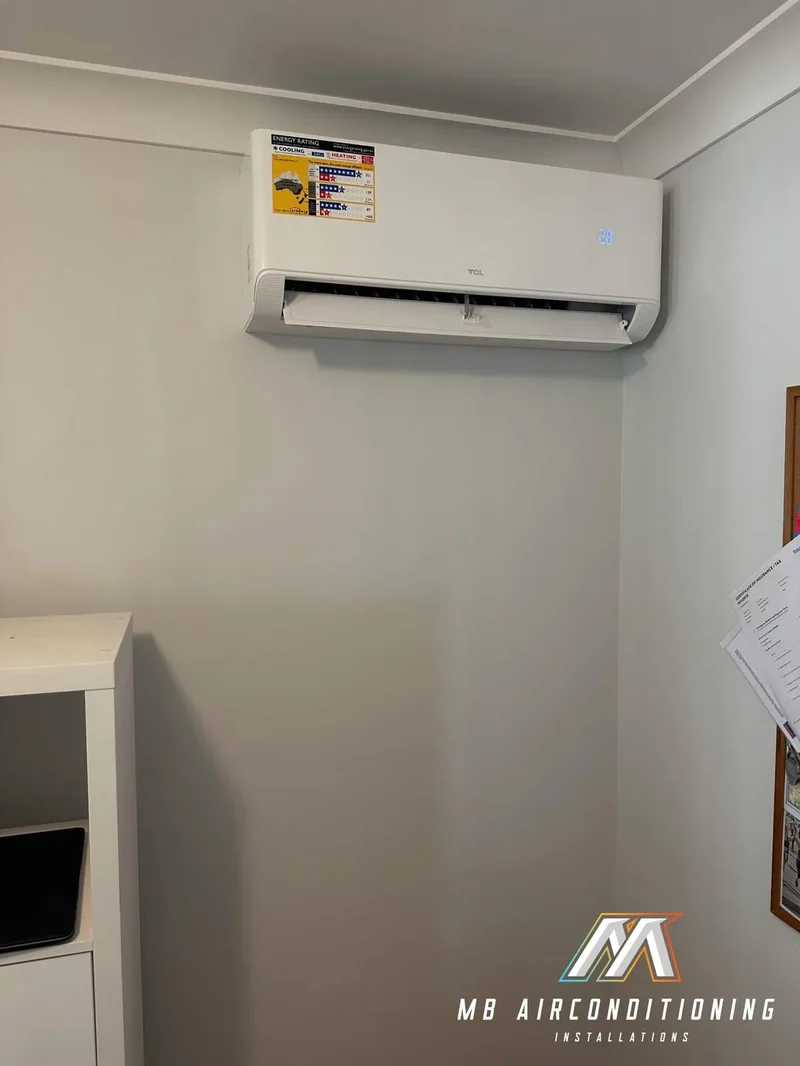 Split system installed in a hallway beside a doorway