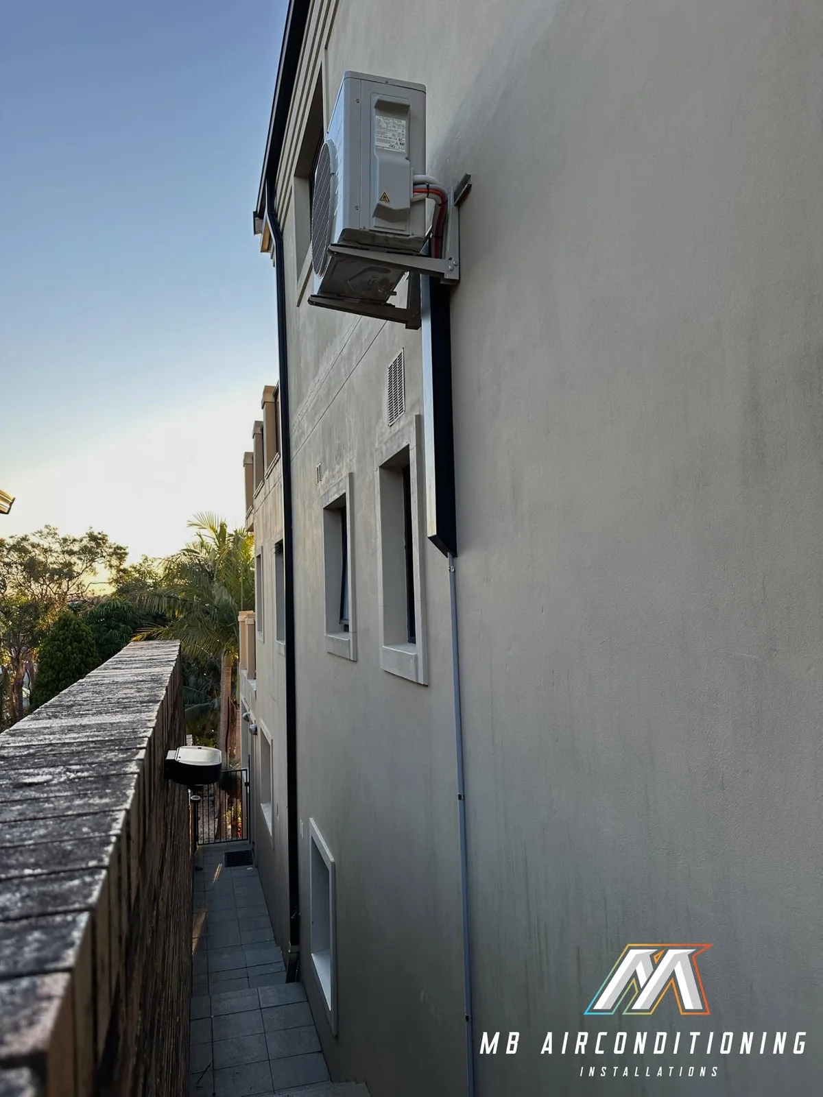 Outdoor air conditioning units along the side of a home