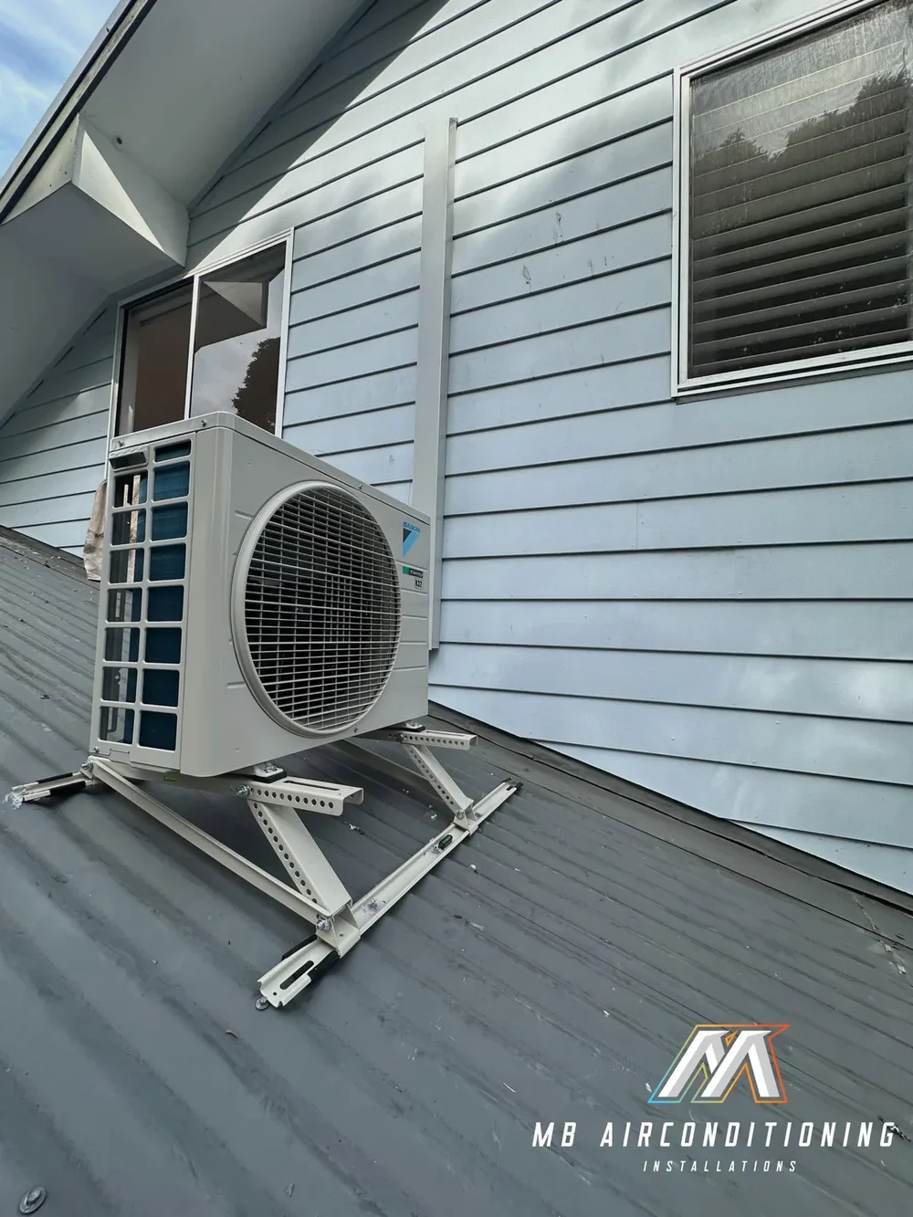 Daikin air conditioning condenser mounted on a roof, kept clear for regular maintenance