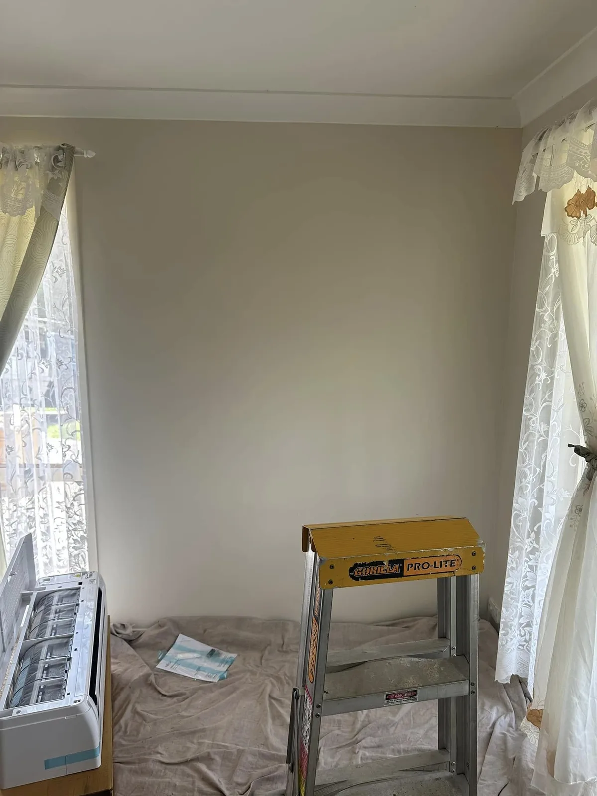 Room prepared for installation work with a ladder and protective floor covering